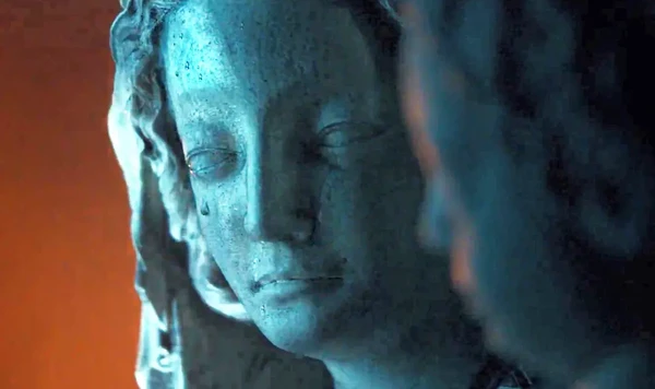 A close - up of a statue during the fire in "Notre-Dame brûle".
